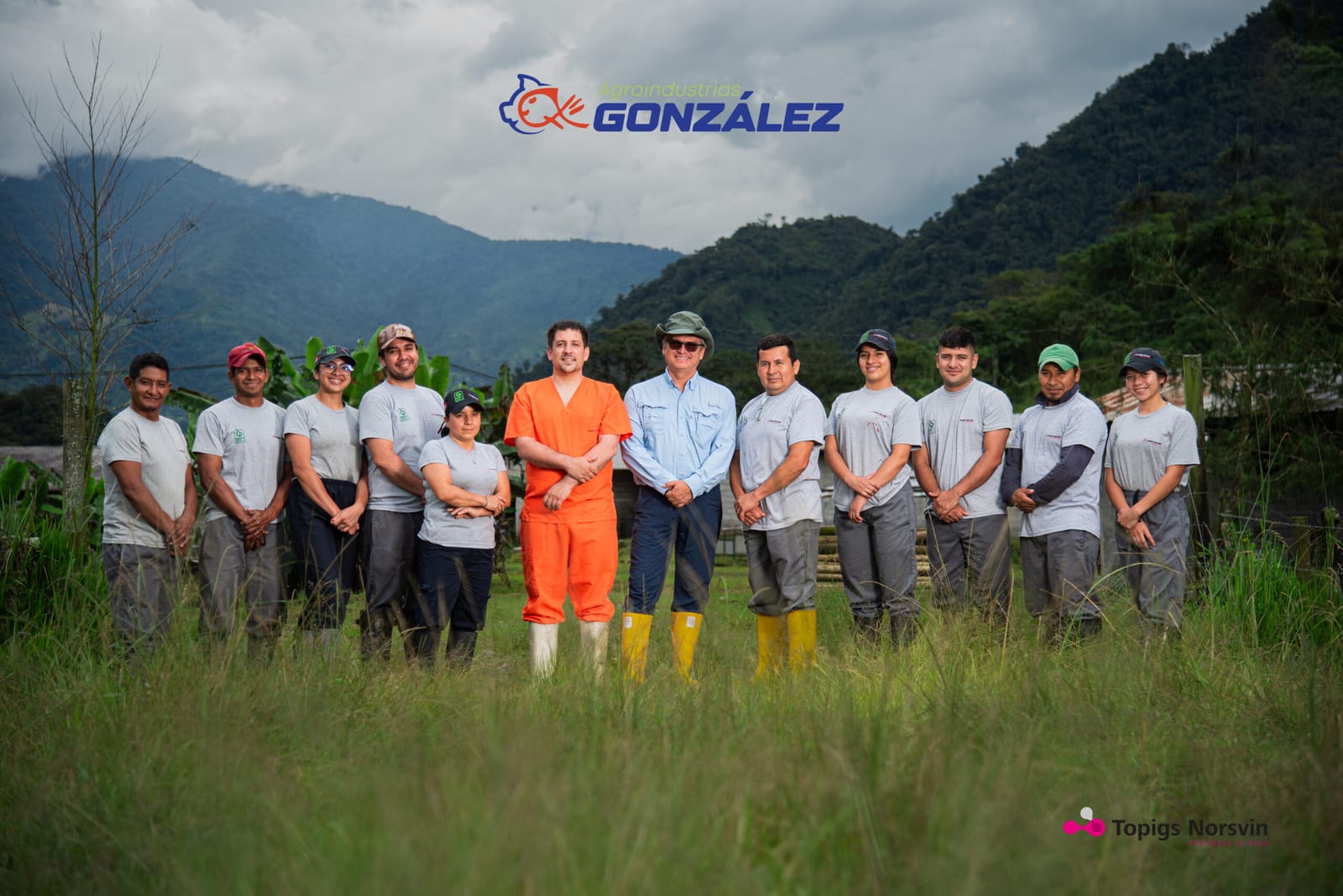 A equipe do grupo reunida em um pasto, com as montanhas amazônicas ao fundo